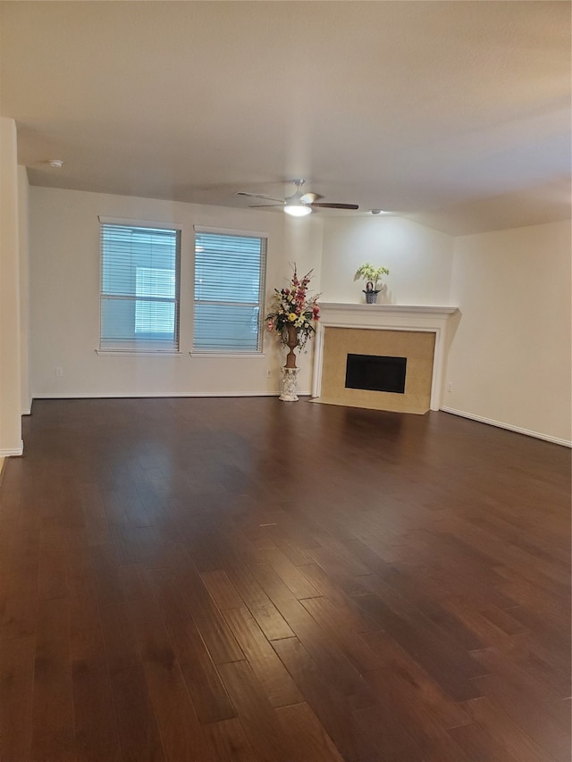 unfurnished living room with ceiling fan and dark hardwood / wood-style floors