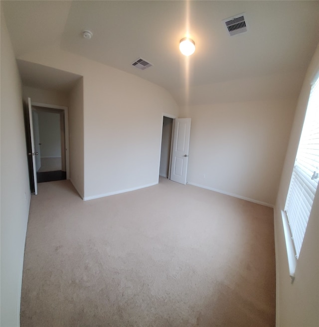 empty room featuring light colored carpet