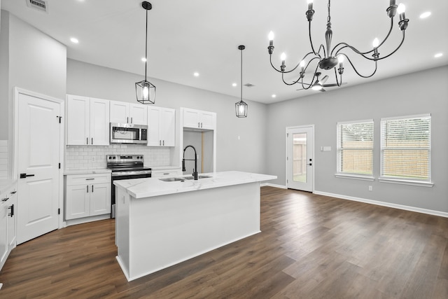 kitchen featuring white cabinetry, an island with sink, stainless steel appliances, dark hardwood / wood-style floors, and sink