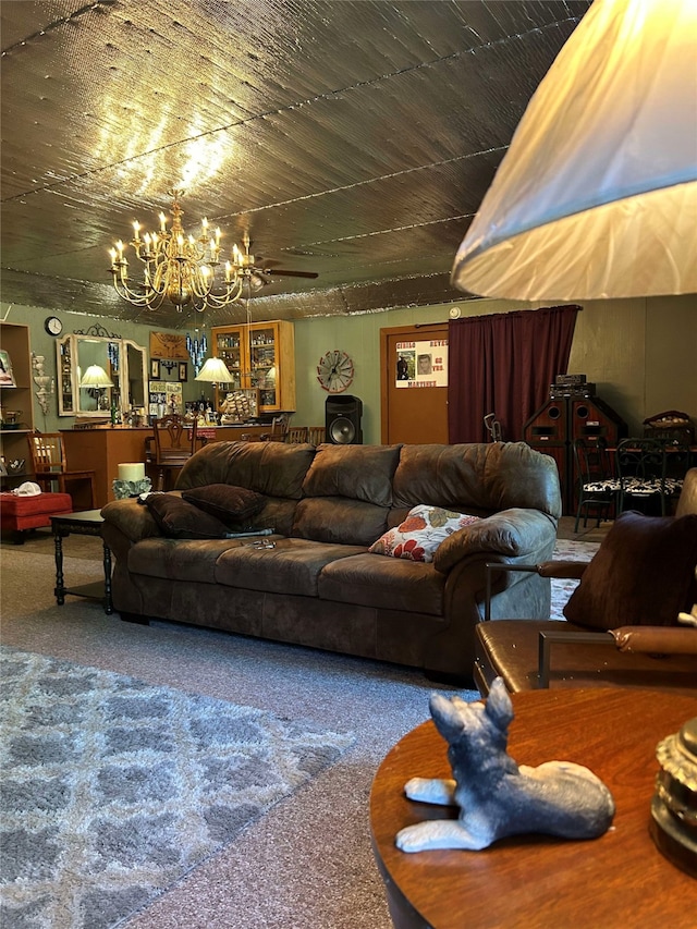 living room with ceiling fan with notable chandelier and carpet flooring