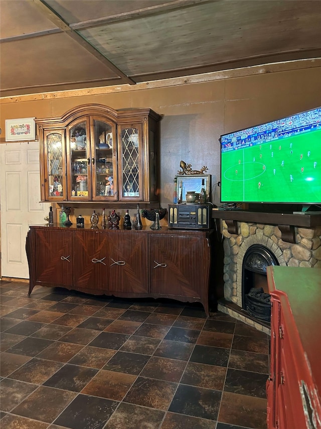 208 S Karnes Ave, Cameron, TX 76520 - living area featuring a stone fireplace and dark stone finish flooring