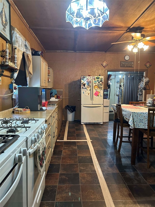 208 S Karnes Ave, Cameron, TX 76520 - kitchen featuring white appliances, ceiling fan, light countertops, a chandelier, and dark stone finish flooring