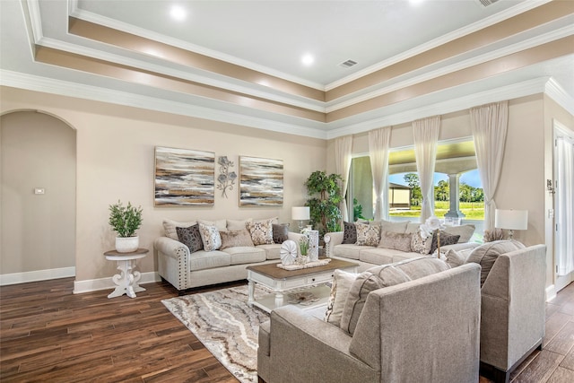 living room with ornamental molding, dark hardwood / wood-style floors, and a tray ceiling