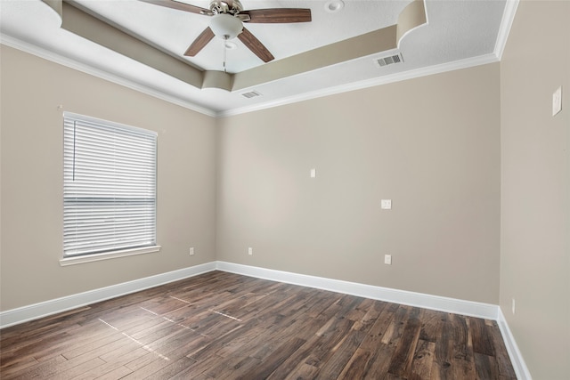 spare room featuring ceiling fan, a raised ceiling, dark hardwood / wood-style floors, and ornamental molding