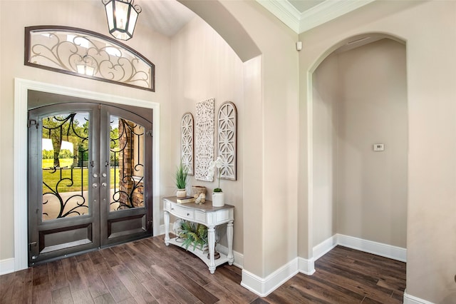 entrance foyer featuring french doors, dark hardwood / wood-style floors, and ornamental molding