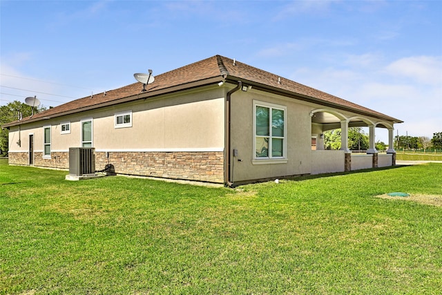 view of home's exterior featuring cooling unit and a yard