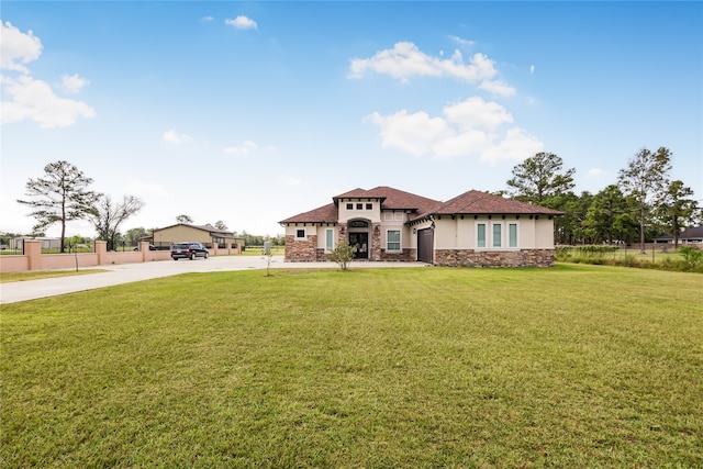 view of front of property featuring a front lawn and a garage