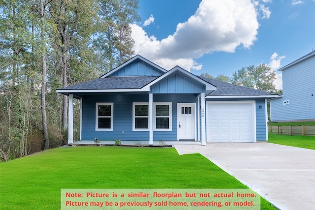 view of front of home featuring a front lawn and a garage