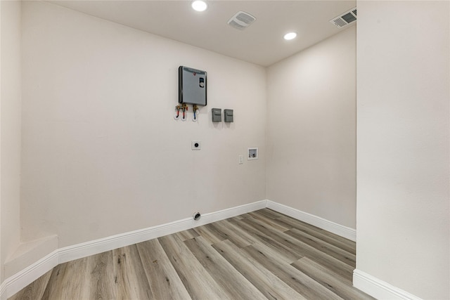 washroom featuring hookup for a washing machine, visible vents, electric dryer hookup, and light wood finished floors