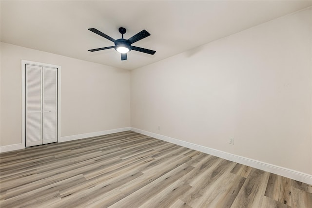 empty room with light hardwood / wood-style flooring and ceiling fan