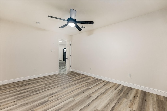 unfurnished room with light wood finished floors, visible vents, baseboards, and ceiling fan