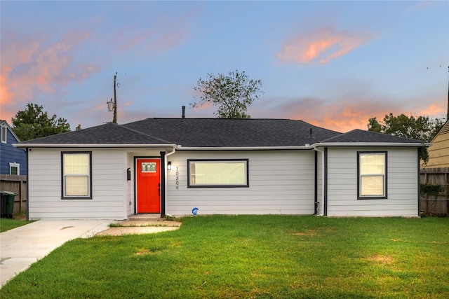 ranch-style home featuring a lawn