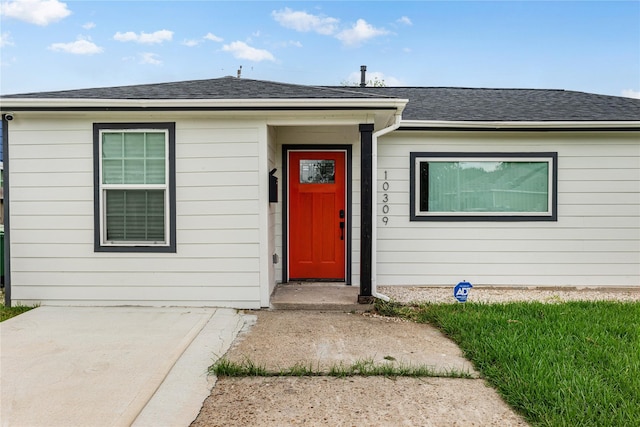 view of front of home with a shingled roof