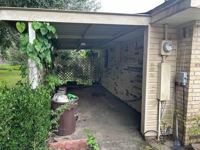 exterior space with fence and an attached carport