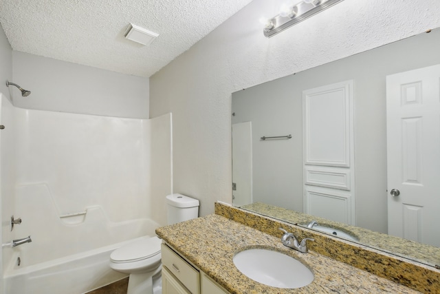 full bathroom featuring a textured ceiling, vanity, toilet, and bathtub / shower combination