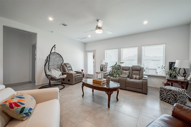 living room featuring light tile patterned flooring and ceiling fan