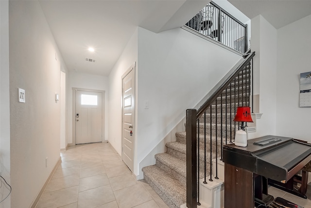 stairway with tile patterned flooring