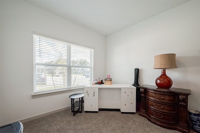 carpeted home office featuring lofted ceiling