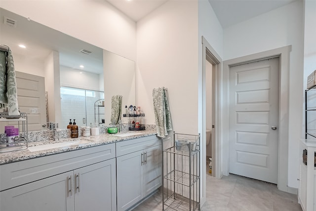 bathroom with a shower with door, toilet, and vanity