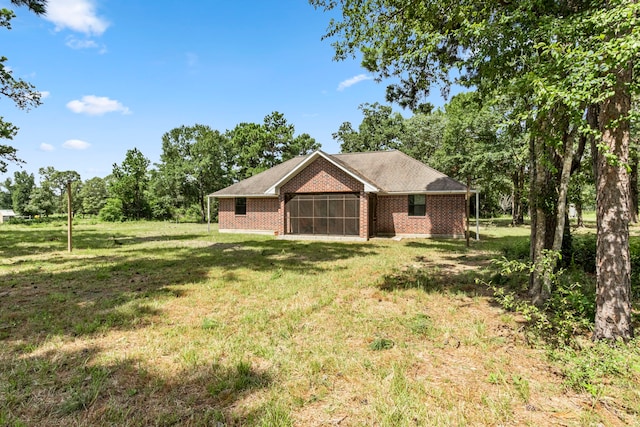 back of property featuring a yard