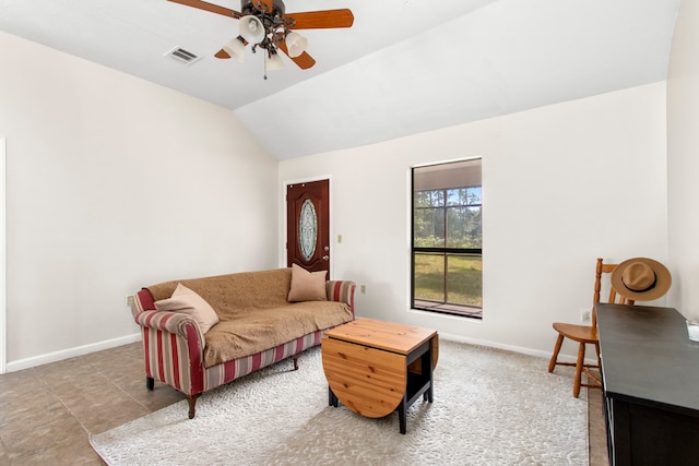 tiled living room with ceiling fan and vaulted ceiling