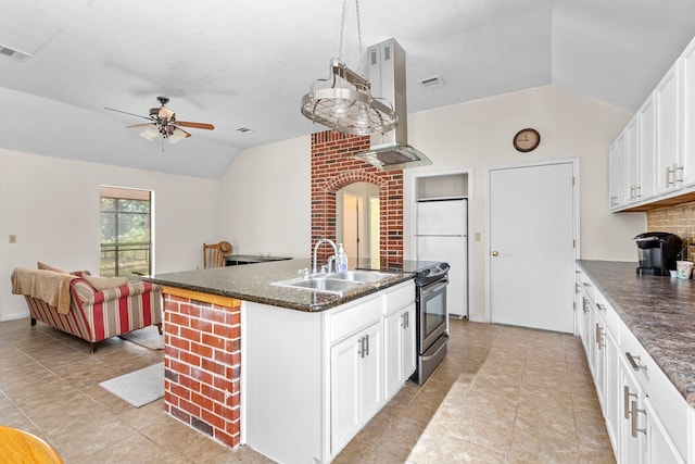 kitchen with white cabinetry, white refrigerator, lofted ceiling, ceiling fan, and a center island with sink