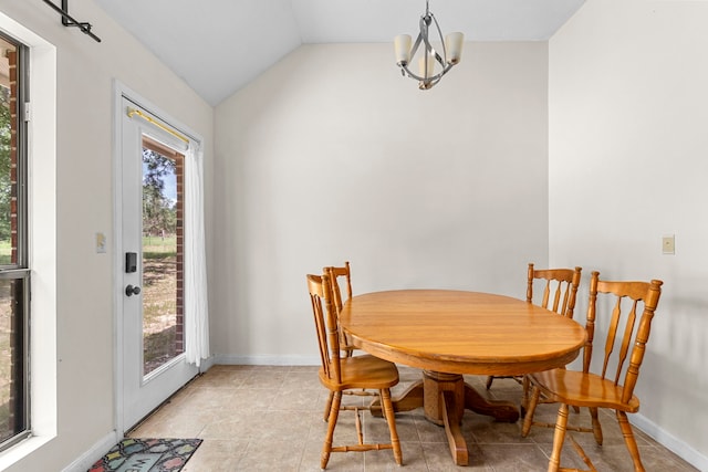 dining area with a notable chandelier, lofted ceiling, and light tile patterned floors