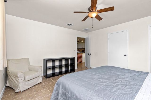 tiled bedroom featuring ceiling fan