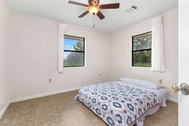 bedroom with light tile patterned flooring and ceiling fan