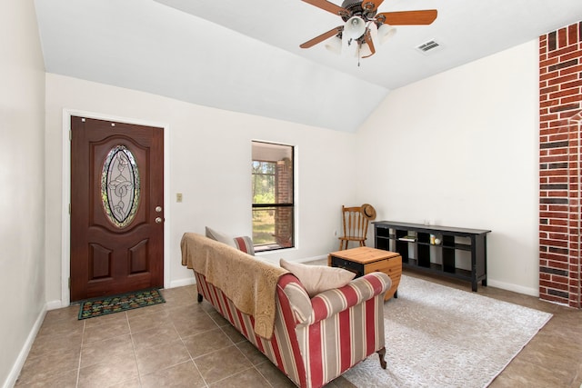 interior space with vaulted ceiling, ceiling fan, and light tile patterned flooring