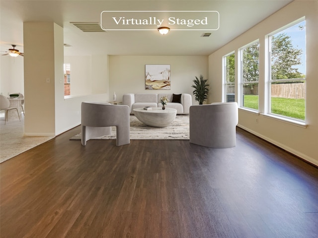 unfurnished living room with ceiling fan and dark hardwood / wood-style flooring