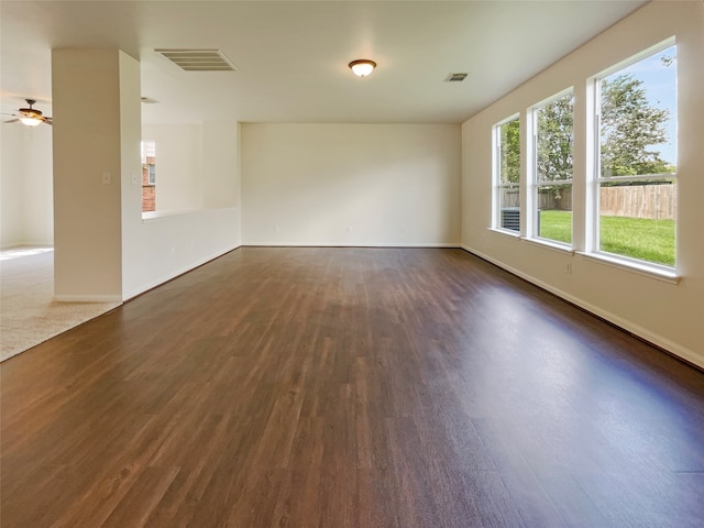 unfurnished room featuring dark hardwood / wood-style floors and ceiling fan