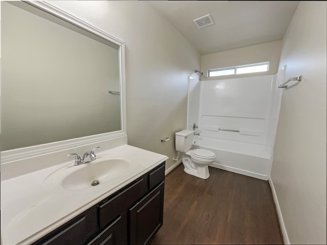 full bathroom with shower / tub combination, vanity, hardwood / wood-style floors, and toilet