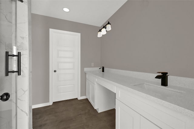 bathroom featuring vanity, a shower with door, and wood-type flooring