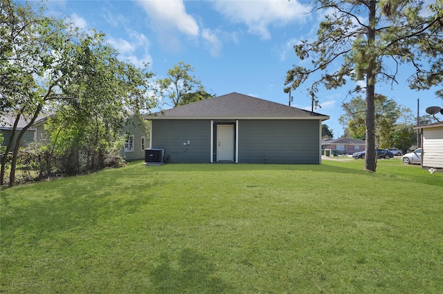 back of property featuring a yard and cooling unit