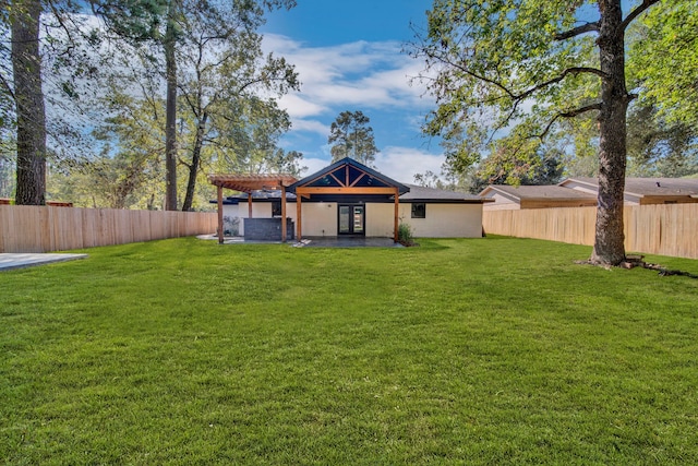 rear view of house with a lawn and a pergola