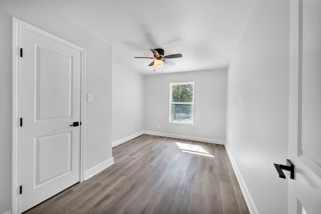 spare room featuring light hardwood / wood-style flooring and ceiling fan