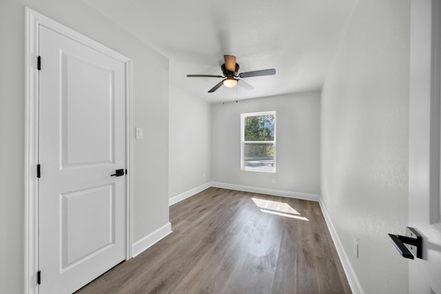 empty room with light hardwood / wood-style floors and ceiling fan