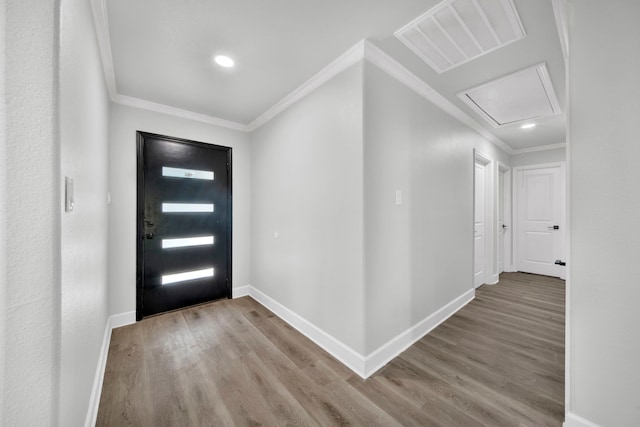 entrance foyer featuring crown molding and hardwood / wood-style flooring