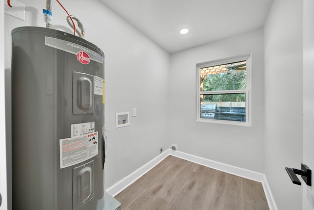 interior space with washer hookup, water heater, and hardwood / wood-style floors