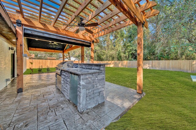 view of patio / terrace featuring ceiling fan, an outdoor kitchen, and a pergola