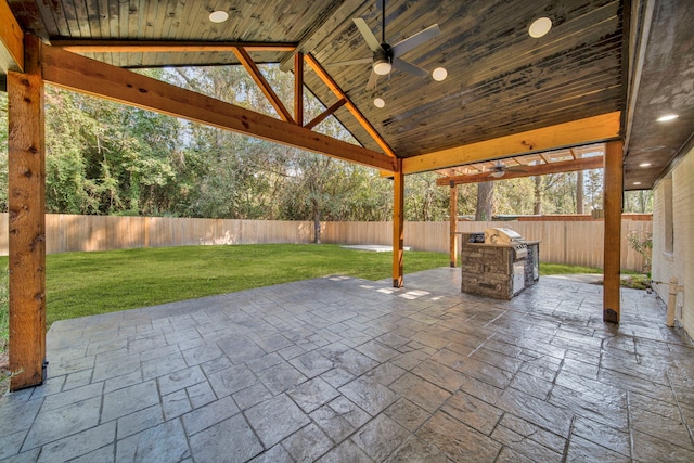 view of patio / terrace featuring ceiling fan, a gazebo, and exterior kitchen