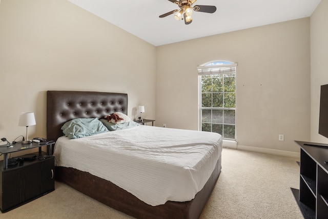 bedroom featuring light carpet and ceiling fan