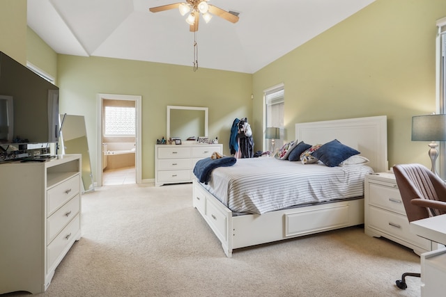 bedroom featuring light carpet, ensuite bath, and ceiling fan