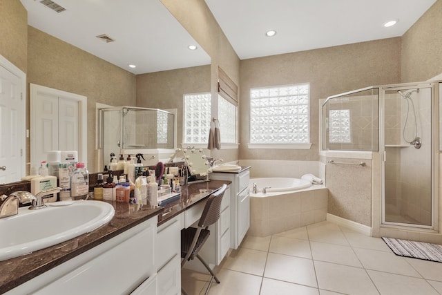 bathroom with independent shower and bath, vanity, and tile patterned flooring