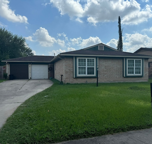 ranch-style house featuring a garage and a front lawn