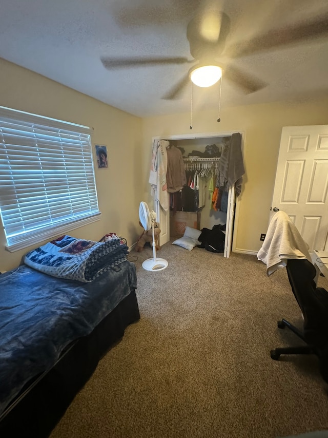 carpeted bedroom with a closet and ceiling fan