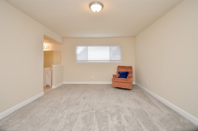 unfurnished room featuring light carpet