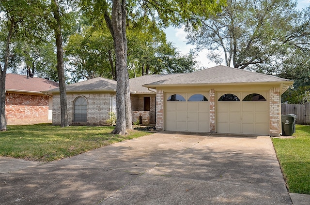 ranch-style home featuring a front yard and a garage