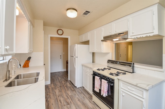 kitchen featuring white appliances, light hardwood / wood-style flooring, backsplash, white cabinets, and sink